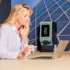 A woman working on her laptop with in the background an Animo OptiVend Touch