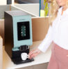 A woman making coffee with an Animo OptiVend Touch